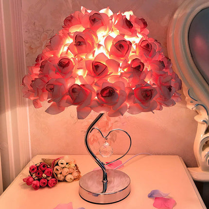 Decorative lamp with pink flower-shaped lights on a table. [SAMATIFY-CLEANED target=all_text]